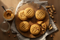 Freshly baked peanut butter cookies on a rustic wooden board